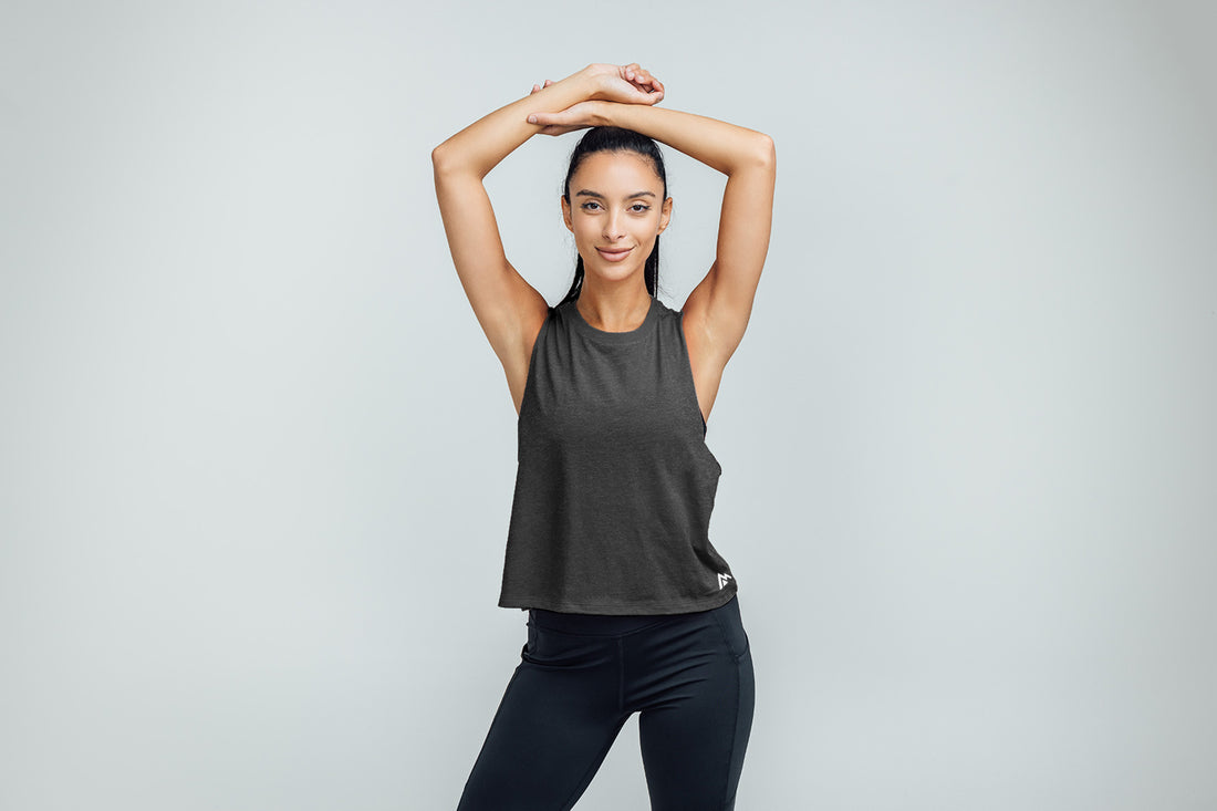 The REP Fitness Women's Peak Cropped Dual-Blend Tank in Heather Charcoal/White on body