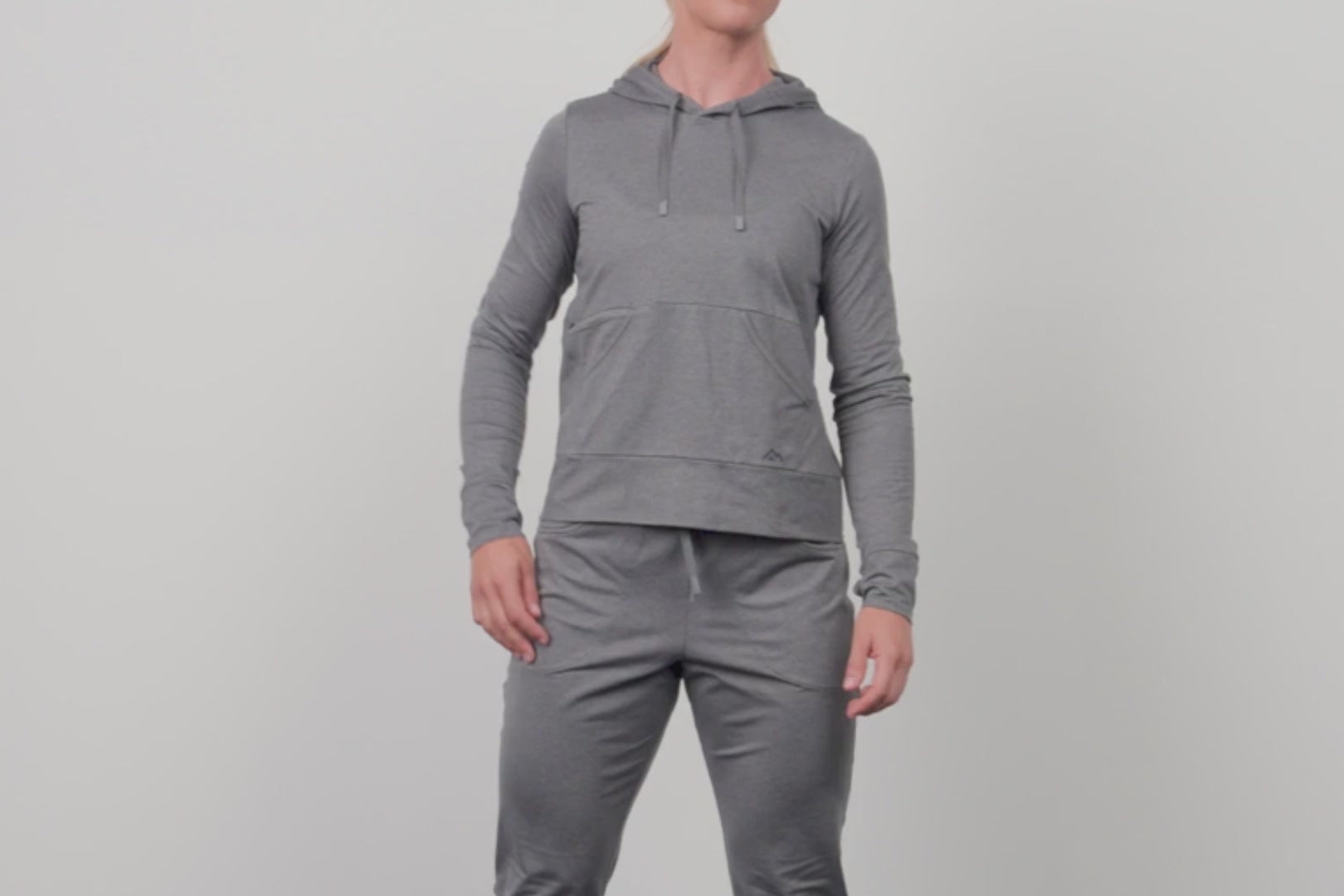 A video of an athlete wearing the Women's Vellus Hoodie in grey in the studio