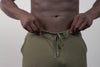 Close-up video of an athlete putting their phone into the zipper pocket on the green Men's Attis Joggers