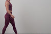 A video of an athlete putting their phone into the back pocket of the Women's Eos Tights in Black, Mauve, Olive, and Wine