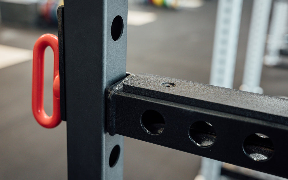 Flip-Down Safeties on 1000 Series Power Rack (Close Up of Plastic Liner on Top and Holes On the Side))