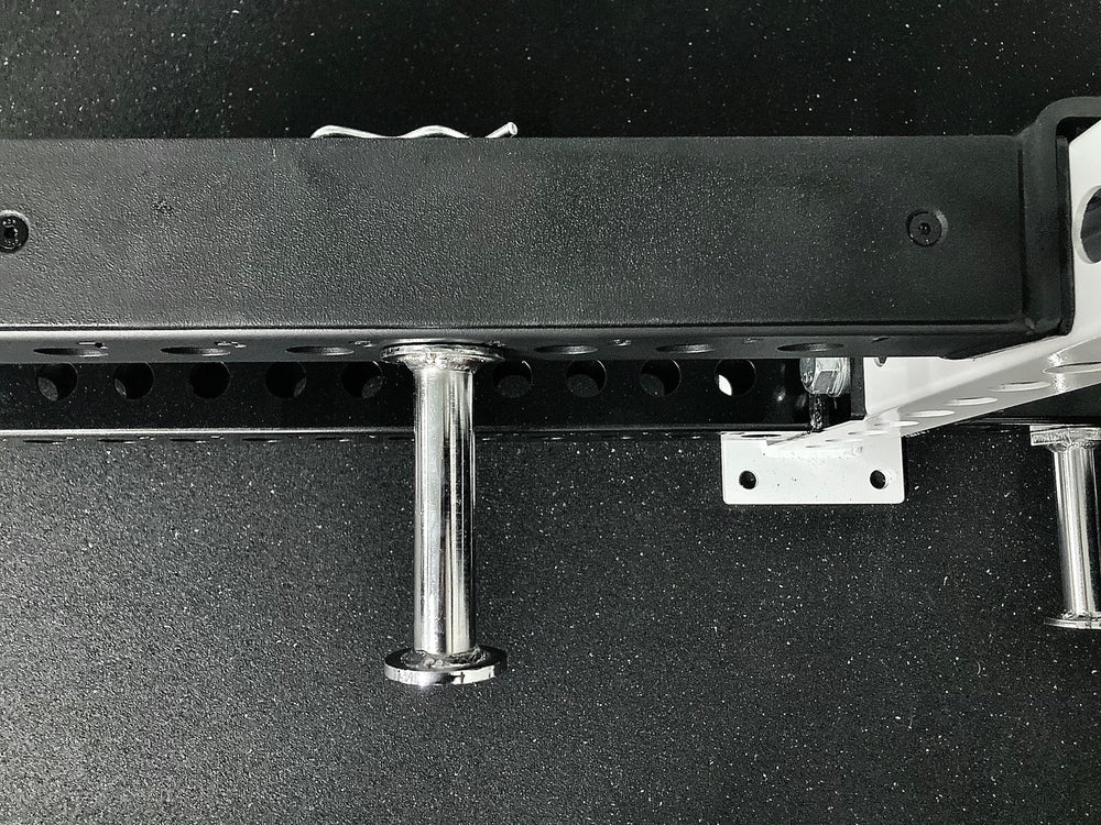 Flip-Down Safeties on Power Rack (Close Up of Plastic Protective Liner on Top With Band Peg Inserted through the side of Flip-Down Safeties)