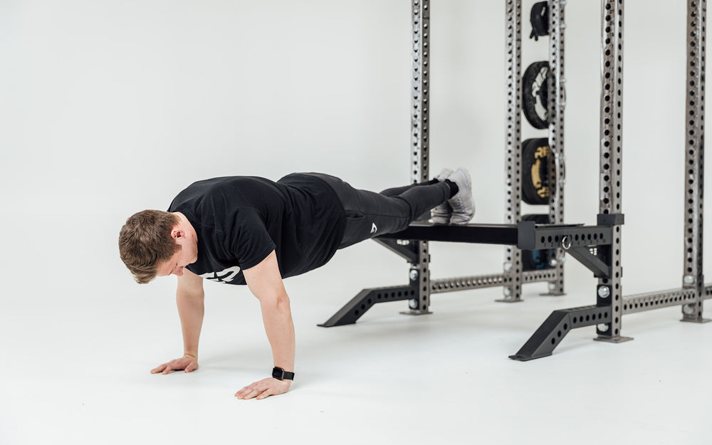 Utility Seat Installed on Spotter Arms on Power Rack Being Used For Decline Push-Ups