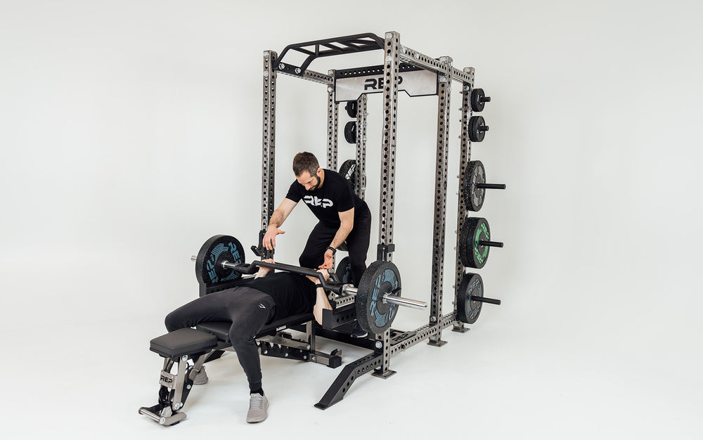 Utility Seat Installed on Crossmembers on Power Rack Being Used as a Spotter Platform