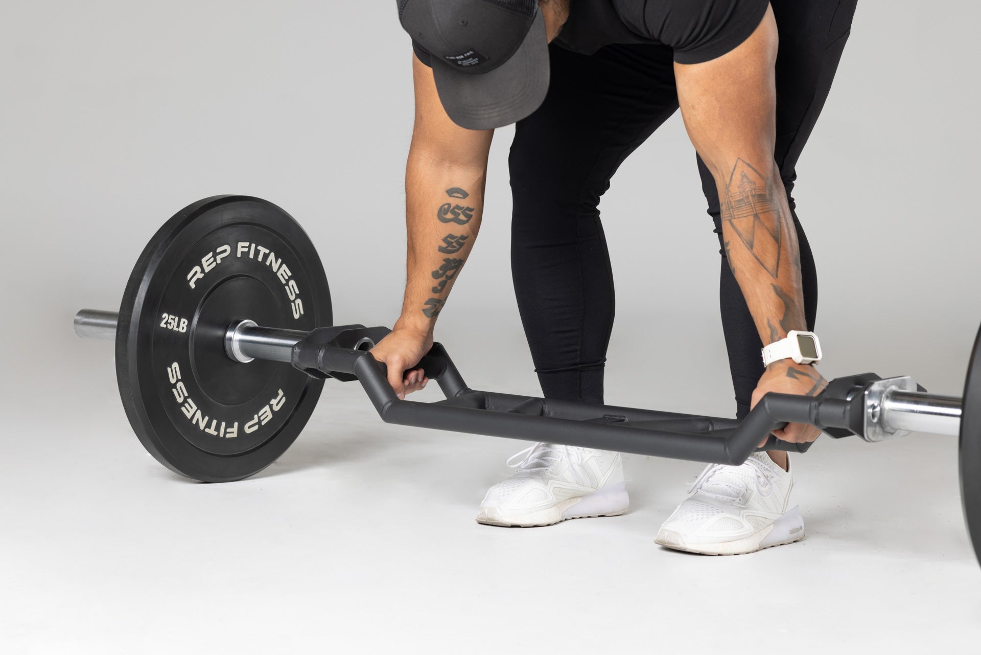 Lifter preparing to use loaded Cambered Swiss Bar from the floor.