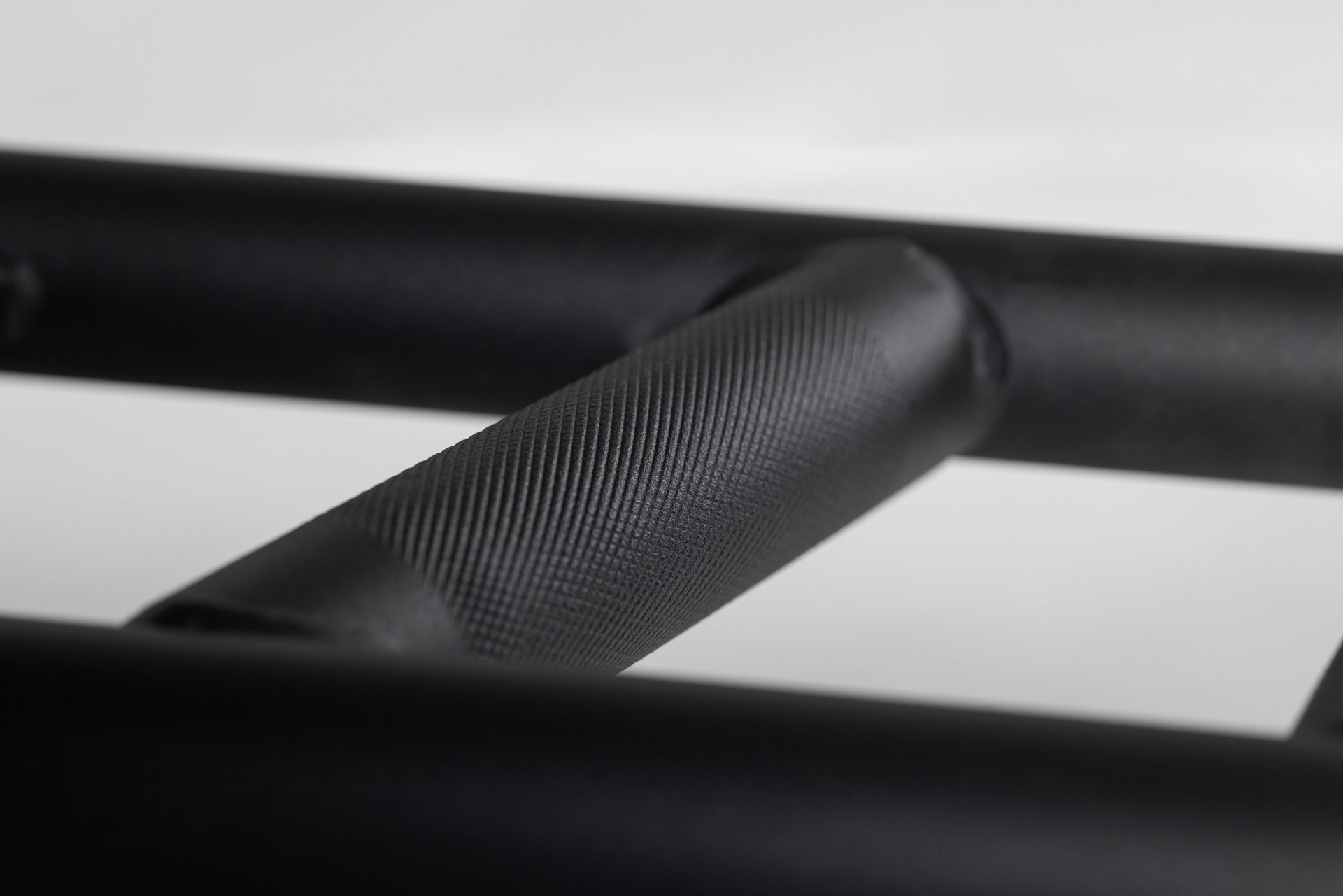 Cambered Swiss Bar knurled handle for the right amount of grip without being too aggressive.