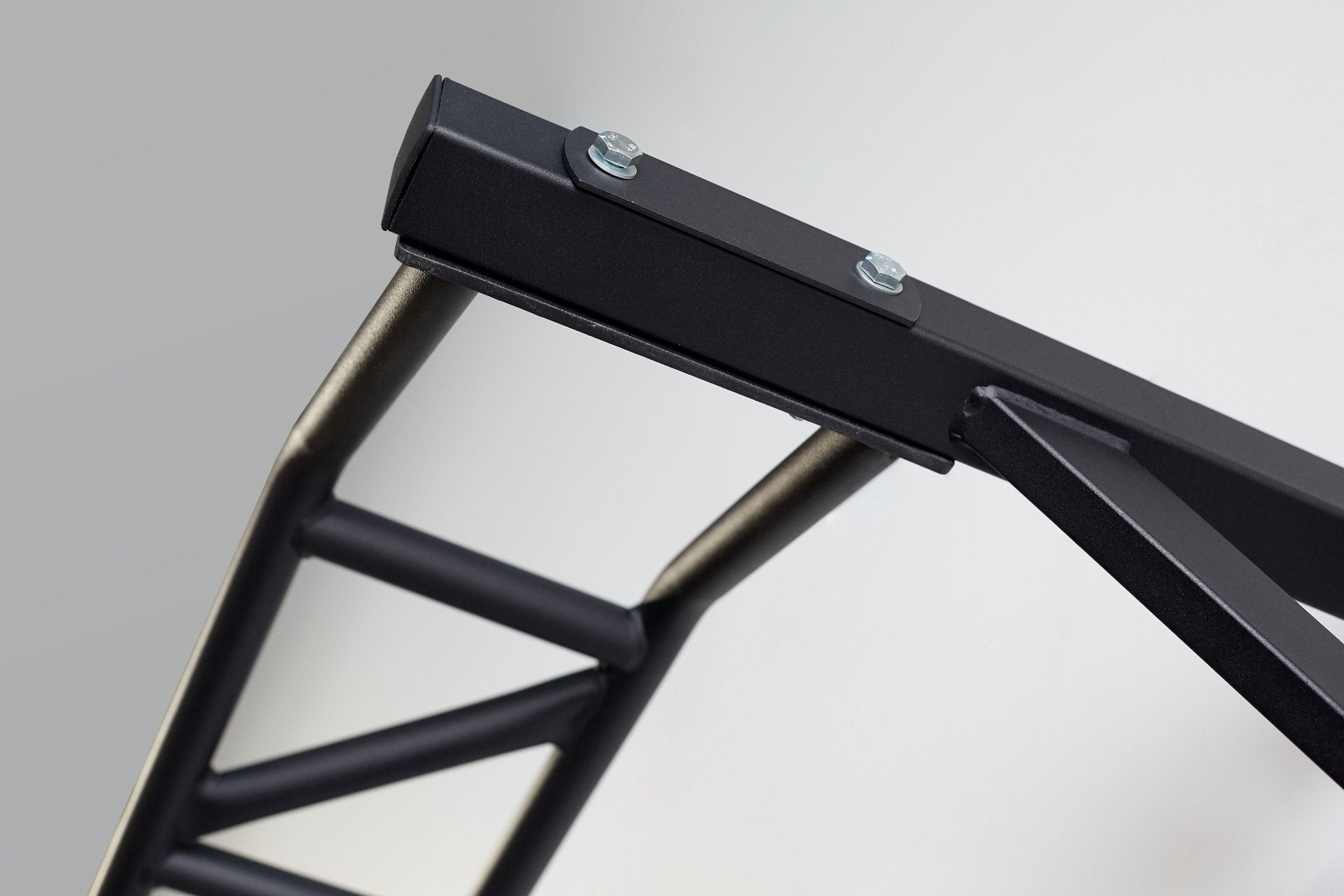 Close-up view of where the multi-grip pull-up bar attaches to the right side support post.