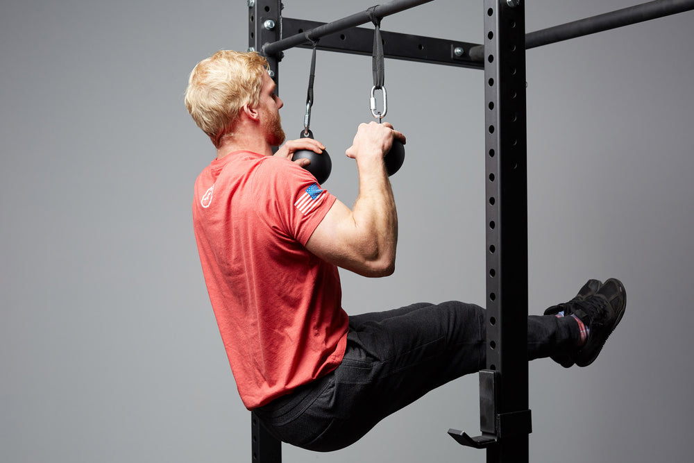 Cannonball Grips Attached To Power Rack For Grip Strength Exercises