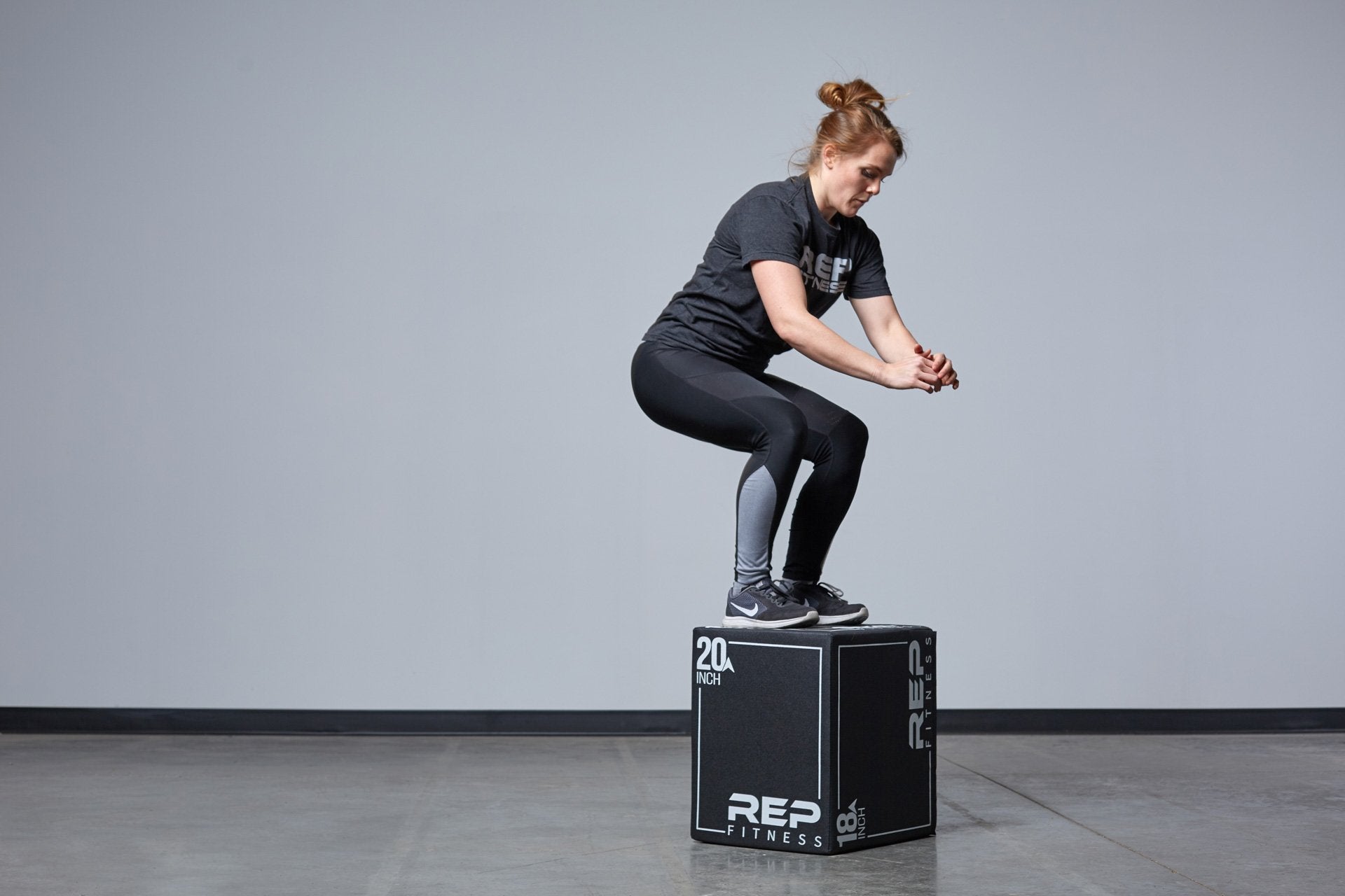 Individual performing box jumps on the Small REP 3-in-1 Soft Plyo Box.