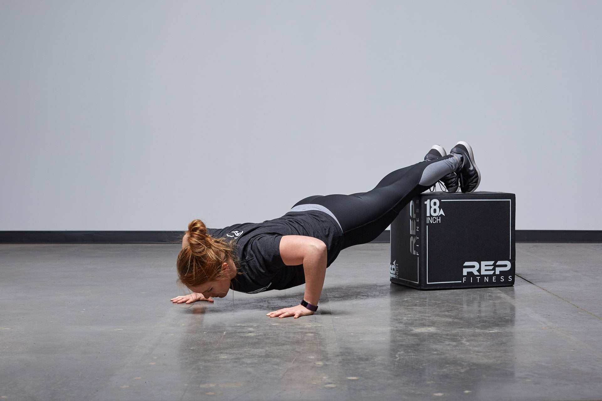 Individual performing decline push-ups on the Small REP 3-in-1 Soft Plyo Box.