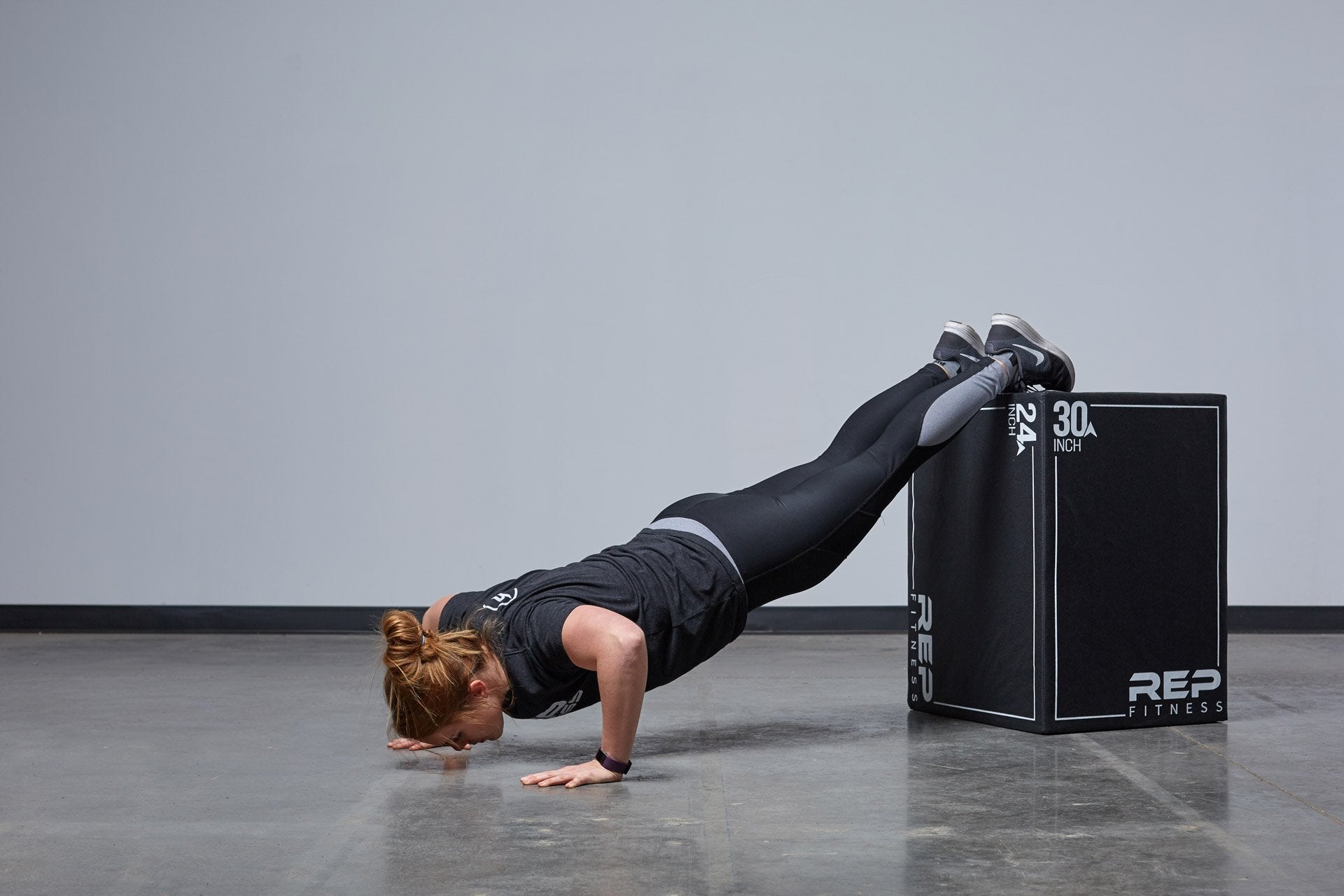 Individual performing decline push-ups on the Large REP 3-in-1 Soft Plyo Box.