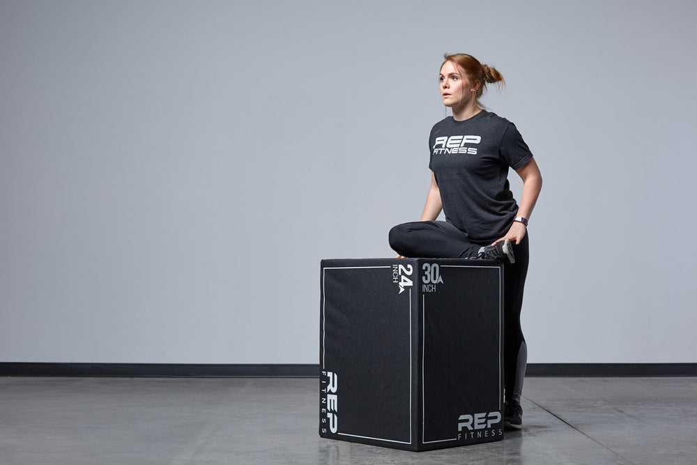 Individual stretching against the Large REP 3-in-1 Soft Plyo Box.