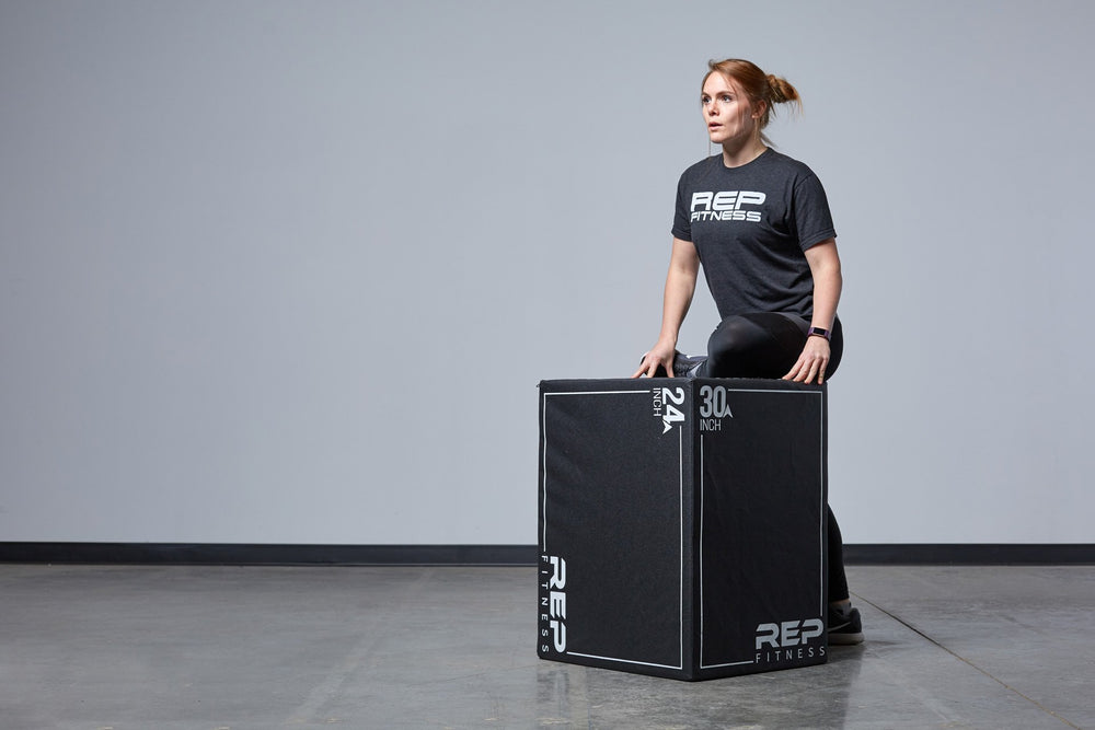 Individual stretching against the Large REP 3-in-1 Soft Plyo Box.