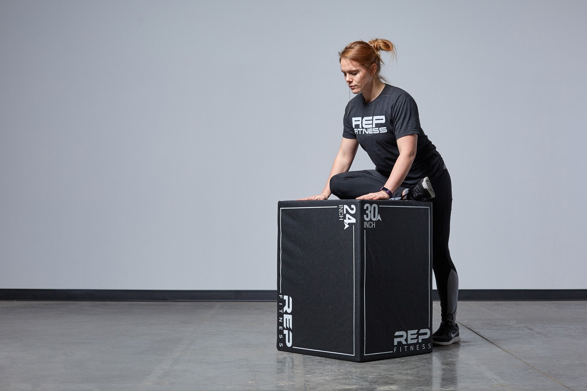 Individual stretching against the Large REP 3-in-1 Soft Plyo Box.
