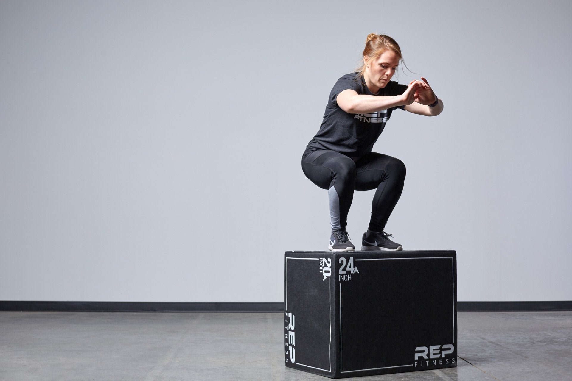 Individual performing box jumps on the Large REP 3-in-1 Soft Plyo Box.