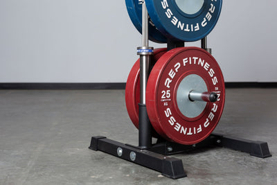 Close-up view of the bottom section of the REP Bar and Weight Plate Tree loaded with a pair of 25kg REP Competition Bumper Plates and two barbells.