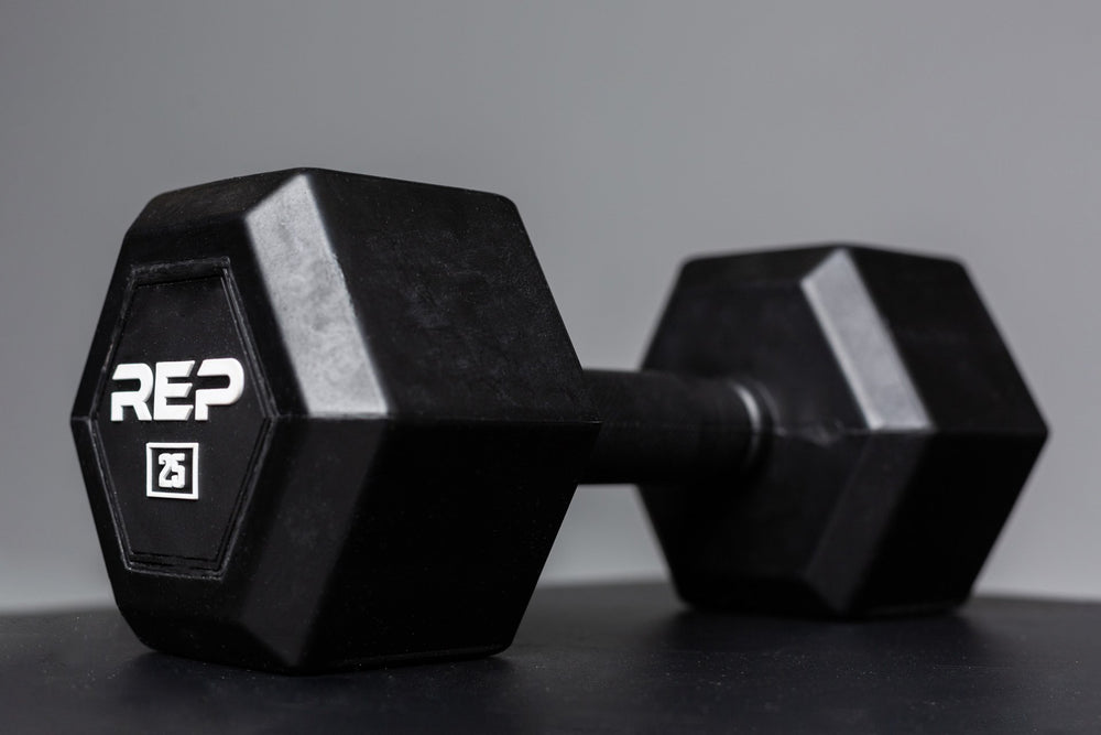 Angled view of a 25lb Rubber Coated Hex Dumbbell showing off the white "REP" logo and weight marking.