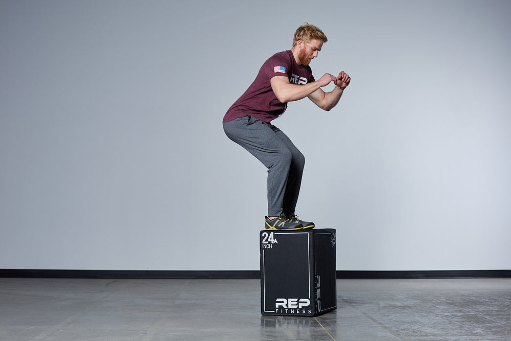 Individual performing box jumps on the Medium REP 3-in-1 Soft Plyo Box.