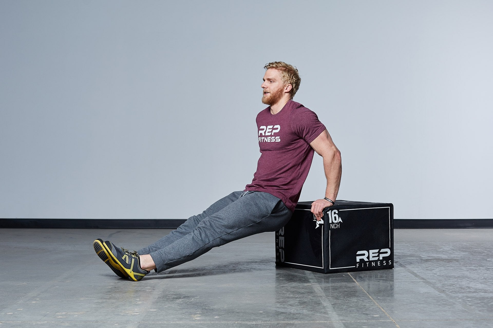 Individual performing dips on the Medium REP 3-in-1 Soft Plyo Box.
