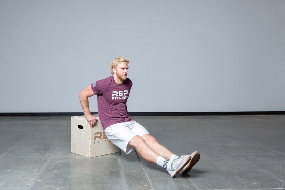 Lifter performing dips on an In-Between REP 3-in-1 Wood Plyo Box.