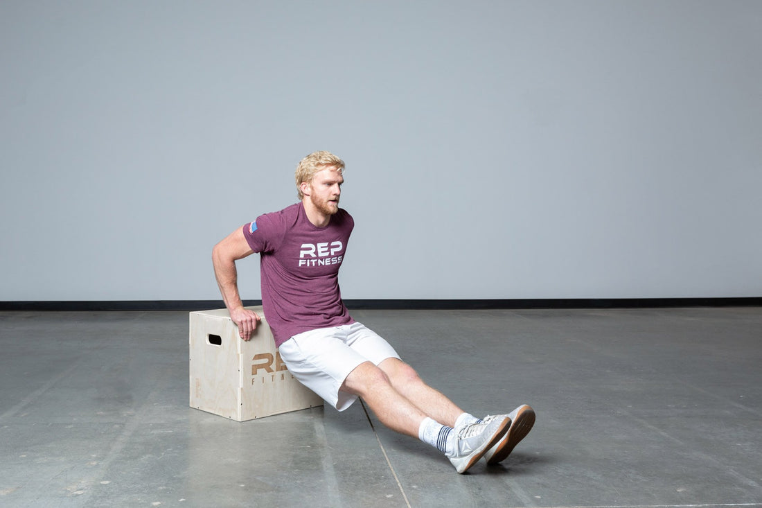 Lifter performing dips on an In-Between REP 3-in-1 Wood Plyo Box.