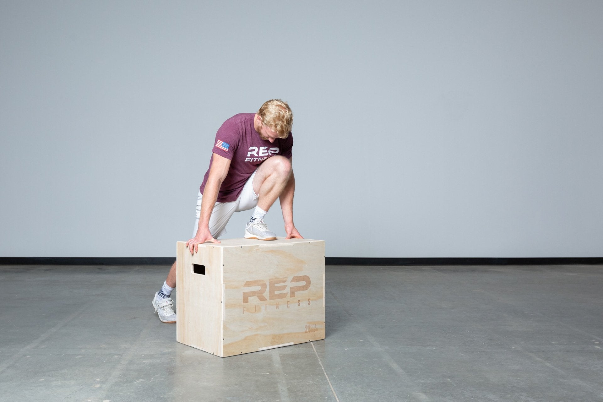 Lifter stretching on a Large REP 3-in-1 Wood Plyo Box.