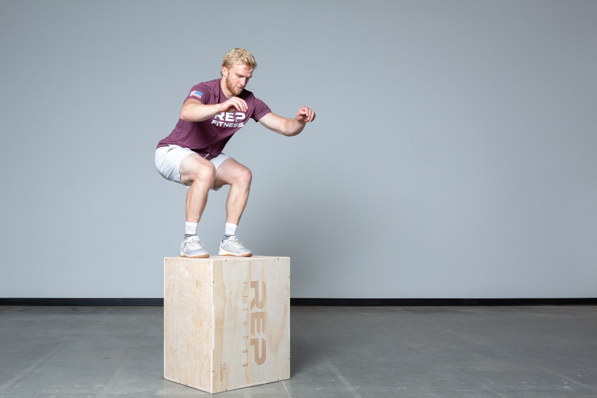 Lifter performing box jumps on a Large REP 3-in-1 Wood Plyo Box.