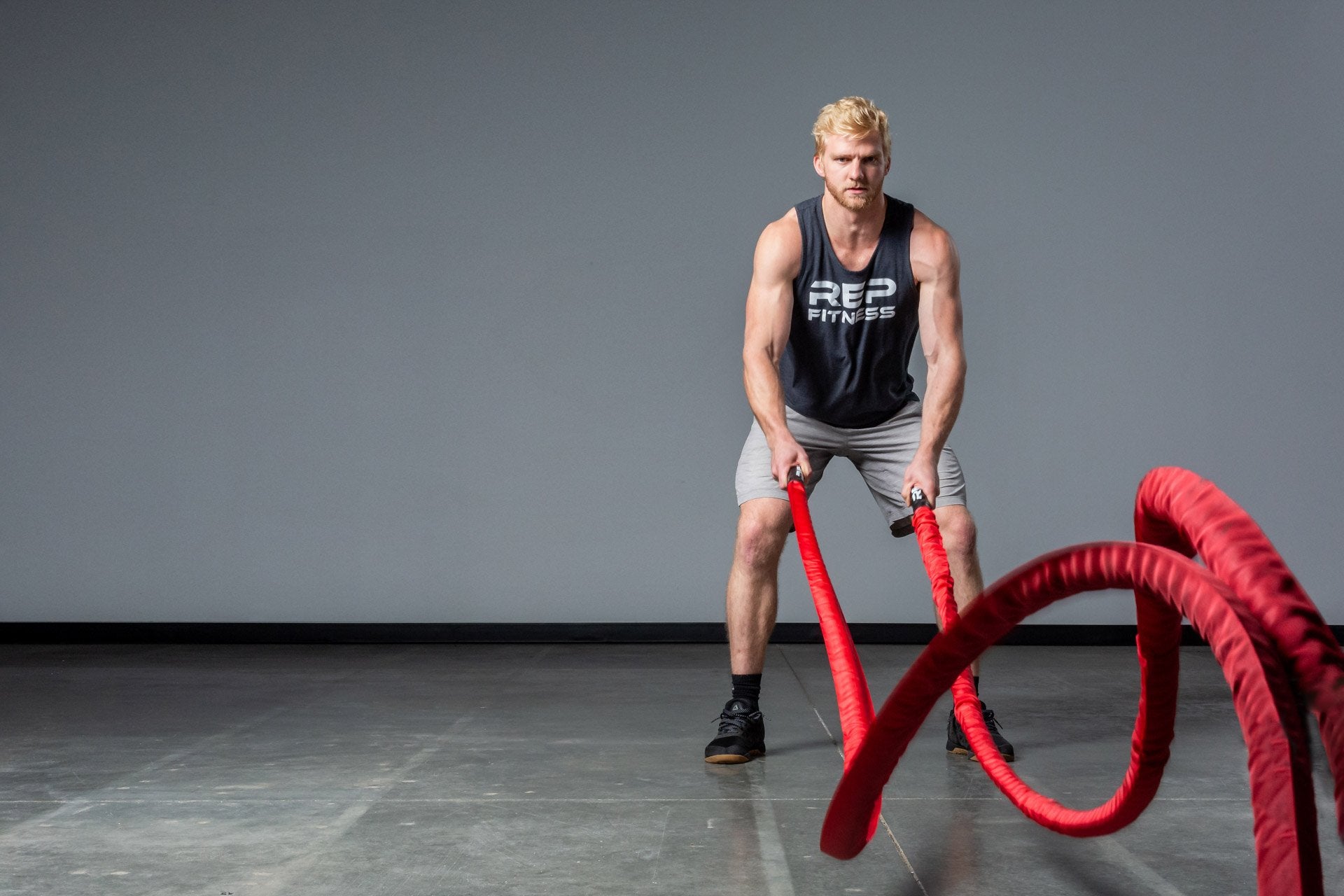 Exercising with red Battle Ropes