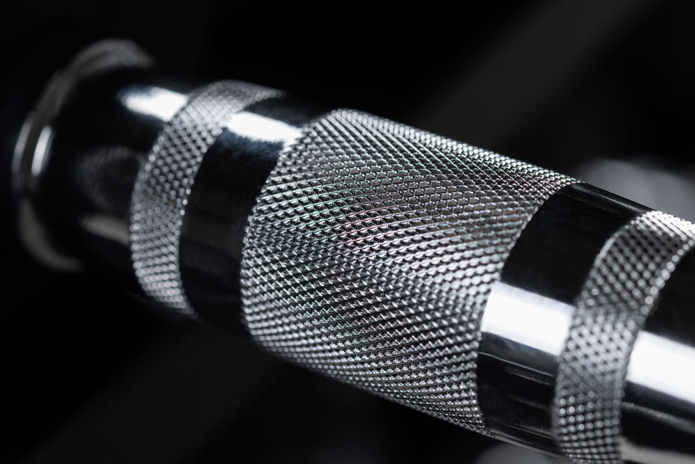 Close-up view of the knurled ergonomic handle of a REP Ergo Hex Dumbbell.