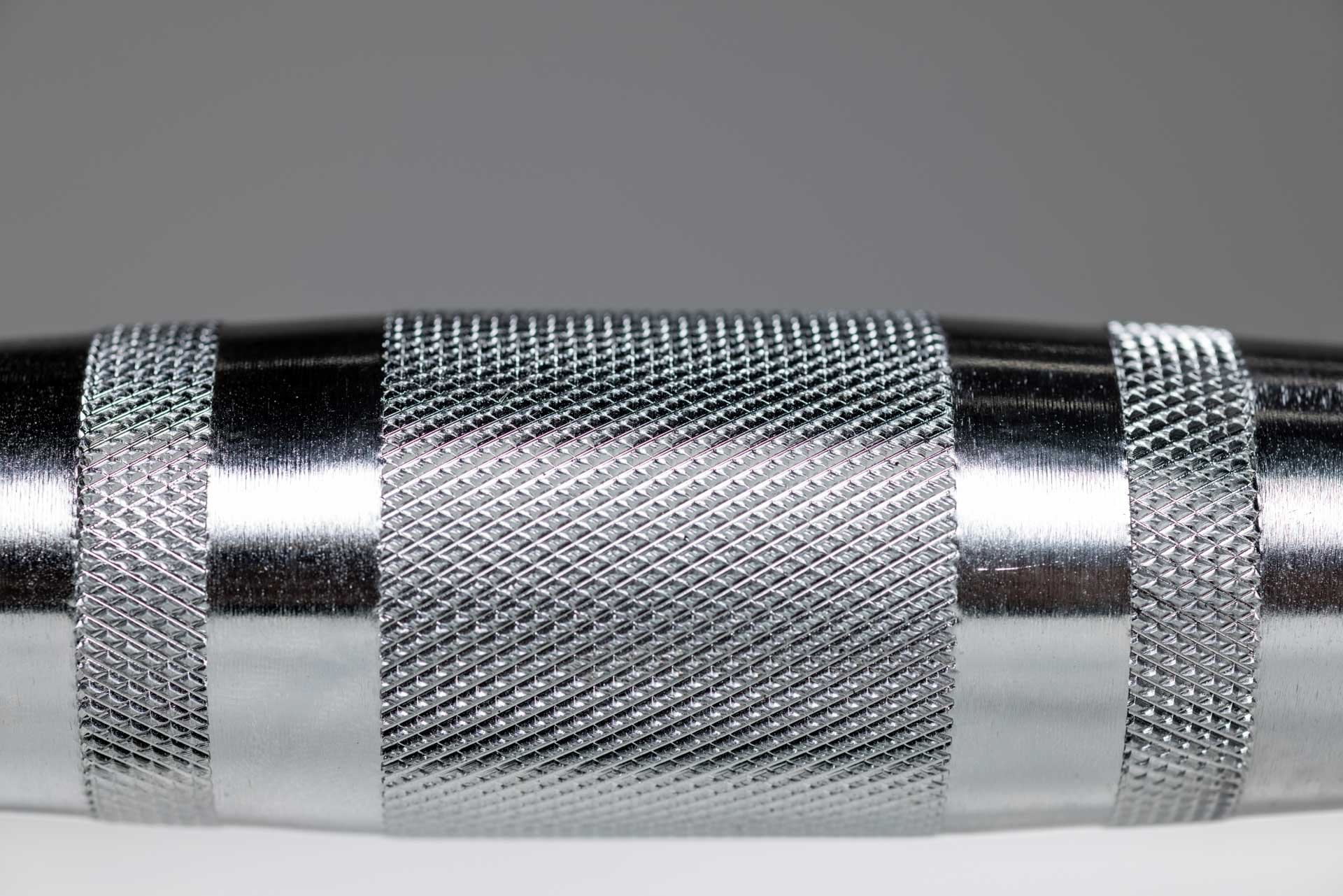 Close-up view of the knurled ergonomic handle of a REP Ergo Hex Dumbbell.