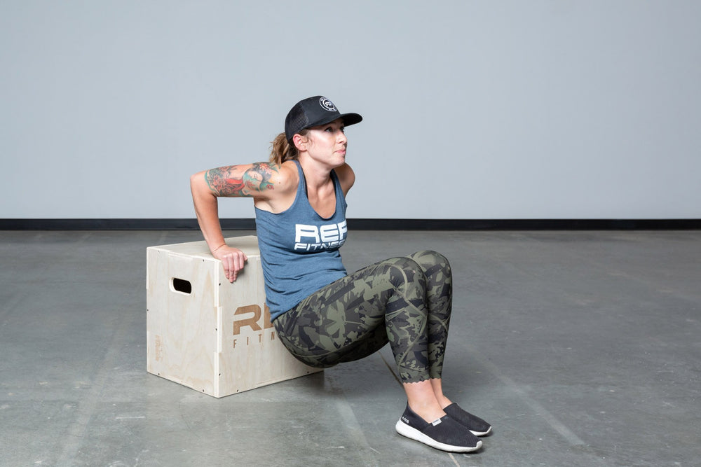 Lifter performing dips on an In-Between REP 3-in-1 Wood Plyo Box.