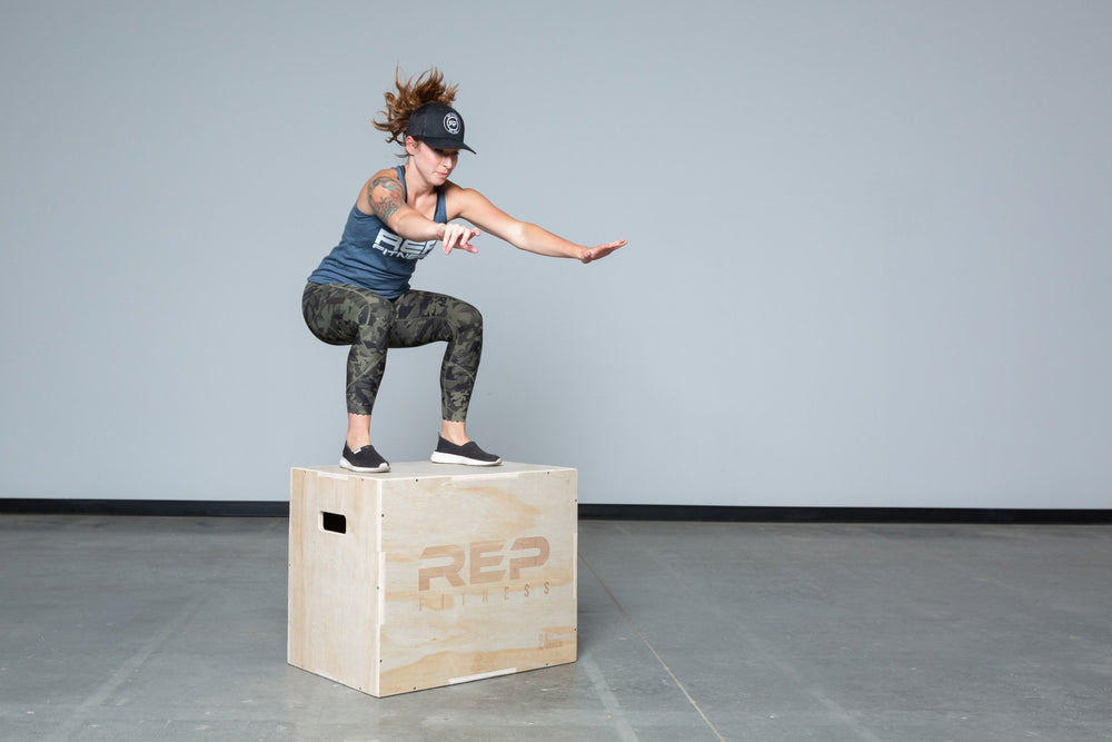 Lifter performing box jumps on a Large REP 3-in-1 Wood Plyo Box.