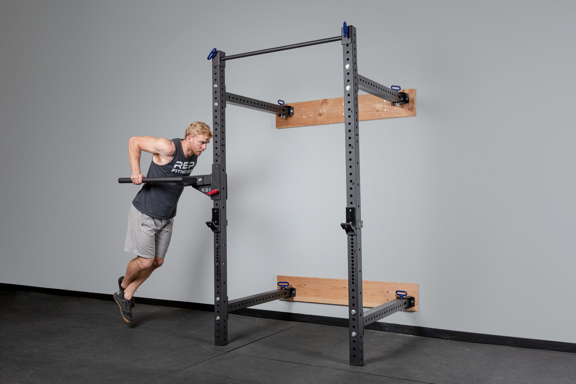 PR-4100 Folding Squat Rack with Dip Station Installed and Being Used for Dips