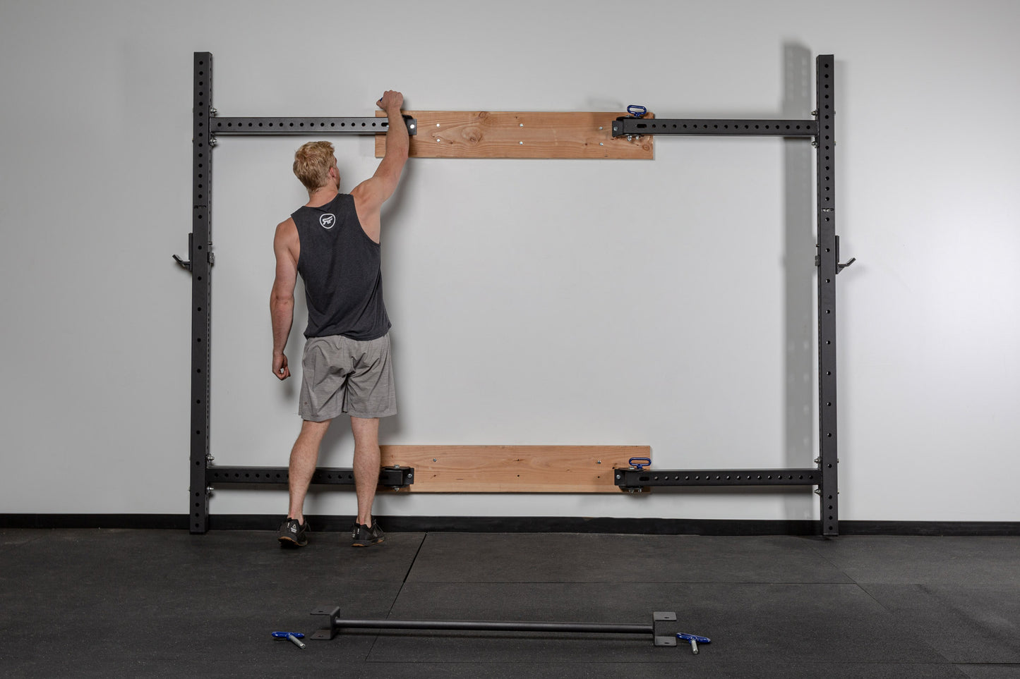 PR-4100 Folding Squat Rack Stored Flat Against The Wall