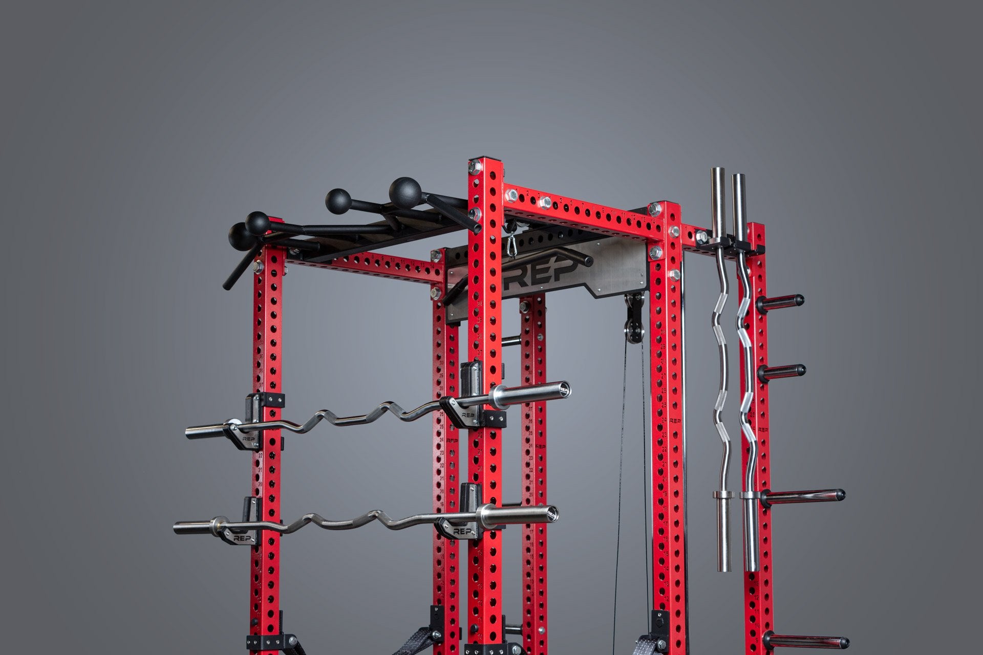 Rackable curl bars being shown racked on j-cups on a PR-5000 rack.