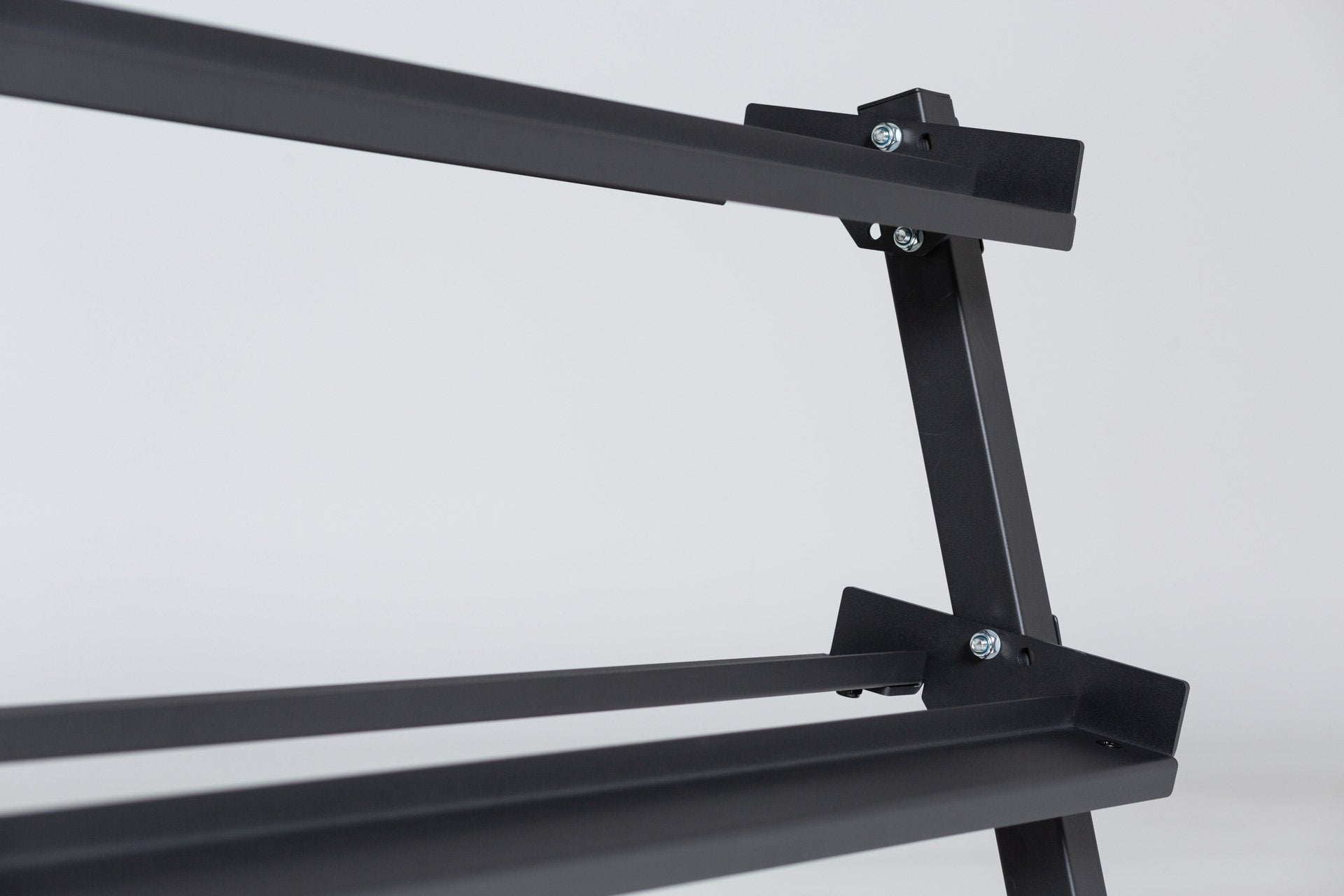 Close-up angled view of the right side of the top and middle shelf and the side support post of a REP Dumbbell Rack.